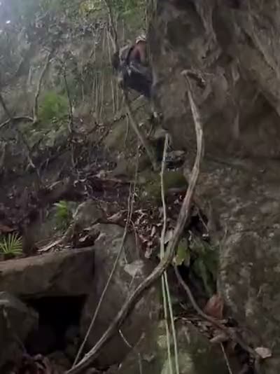 Abseiling back into the jungle at the foot of the wall.